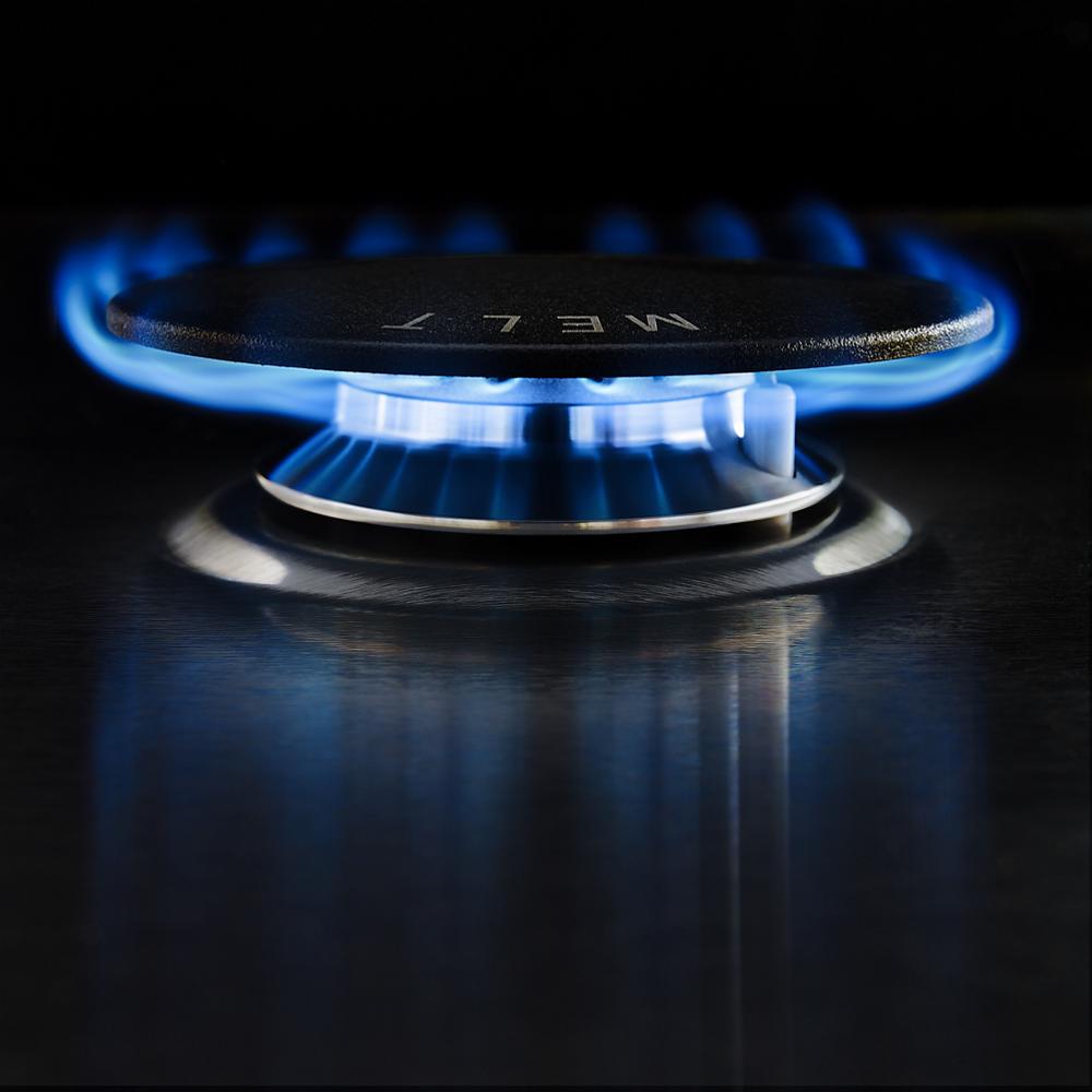 Close-up of lit burner with blue flame on cast iron grate, part of kitchen cooktops and home improvement appliances collection
