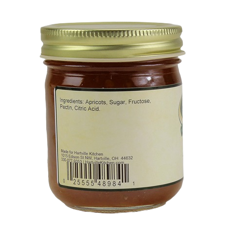 Close-up of apricot jam jar label listing ingredients including apricots, sugar, fructose, pectin, and citric acid