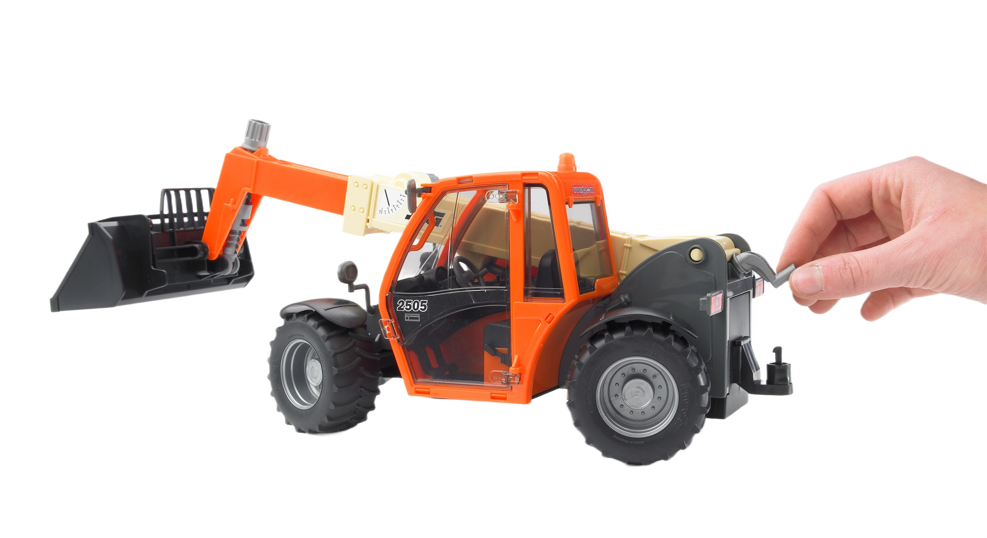 Hand adjusting the detailed orange Bruder JLG 2505 Telehandler toy with large black bucket for home improvement play