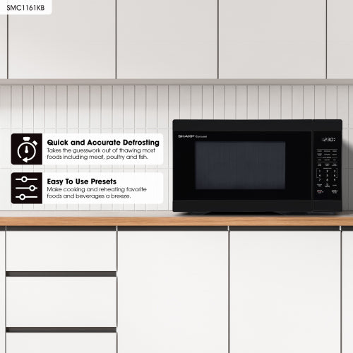 Black countertop microwave oven on wood surface with digital display and kitchen backsplash, in appliances collection
