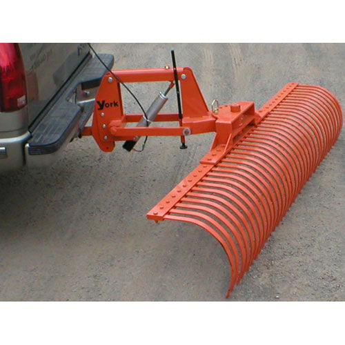 Orange 4-foot adjustable landscape rake attached to a vehicle hitch, designed for earthmoving and landscaping rental equipment at Hartville Hardware.