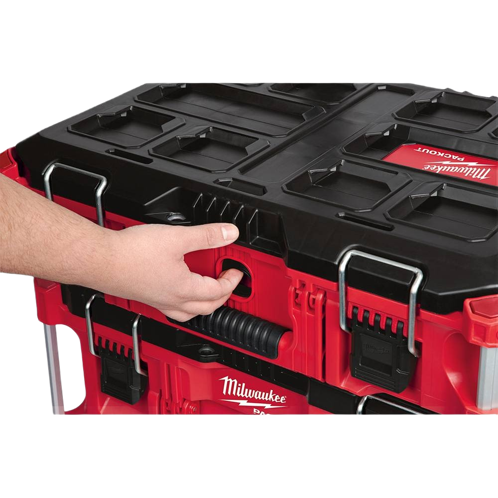 Hand adjusting latch on red and black Milwaukee PACKOUT™ tool box designed for secure tool storage and transport