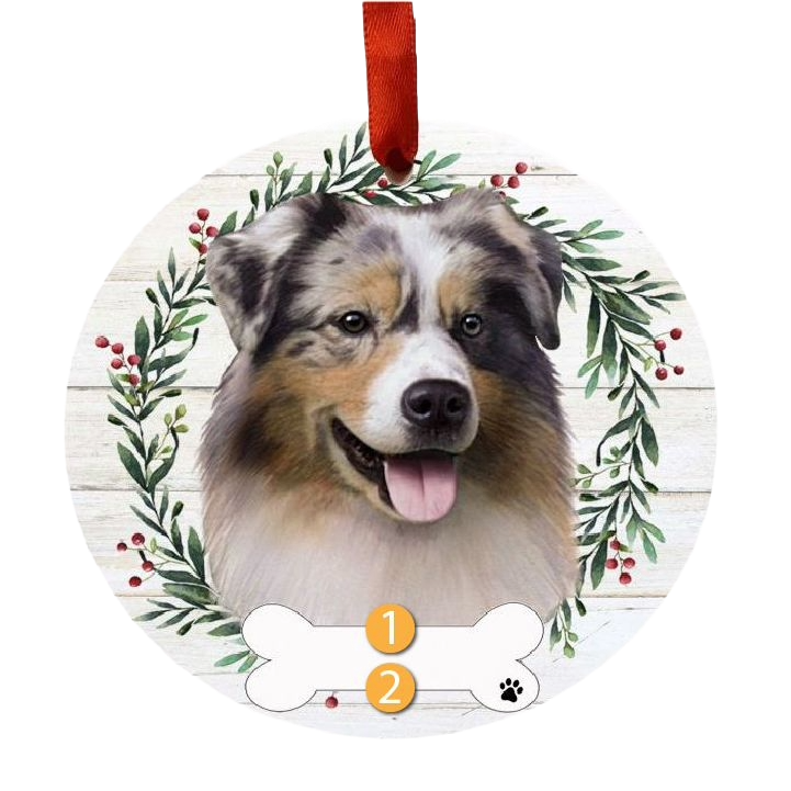 Round Christmas ornament with Australian Shepherd face inside festive greenery wreath and red hanging ribbon