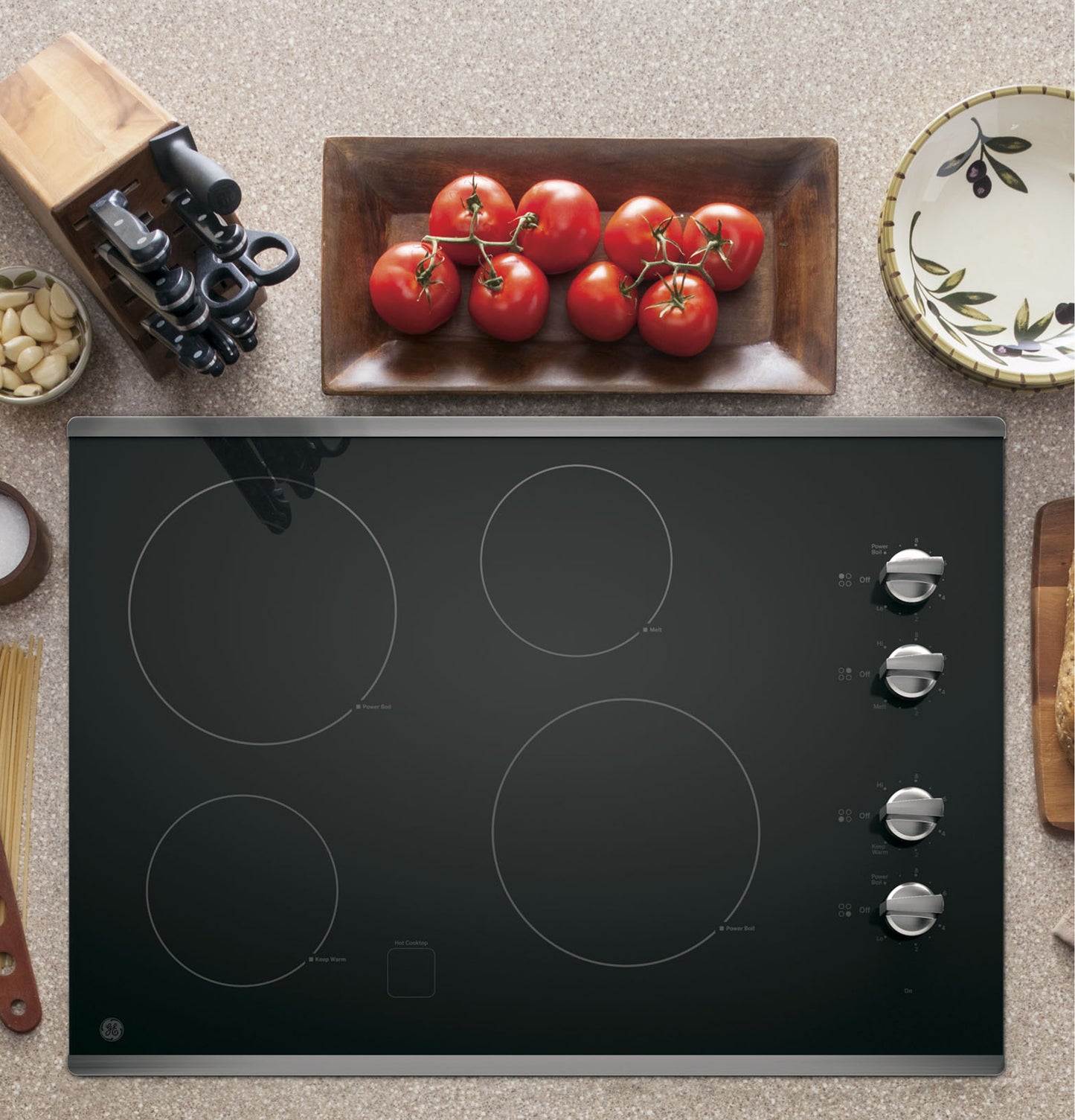 Black built-in electric cooktop with four burner zones and knob controls from Cooktops and Kitchen & Kitchenware collections