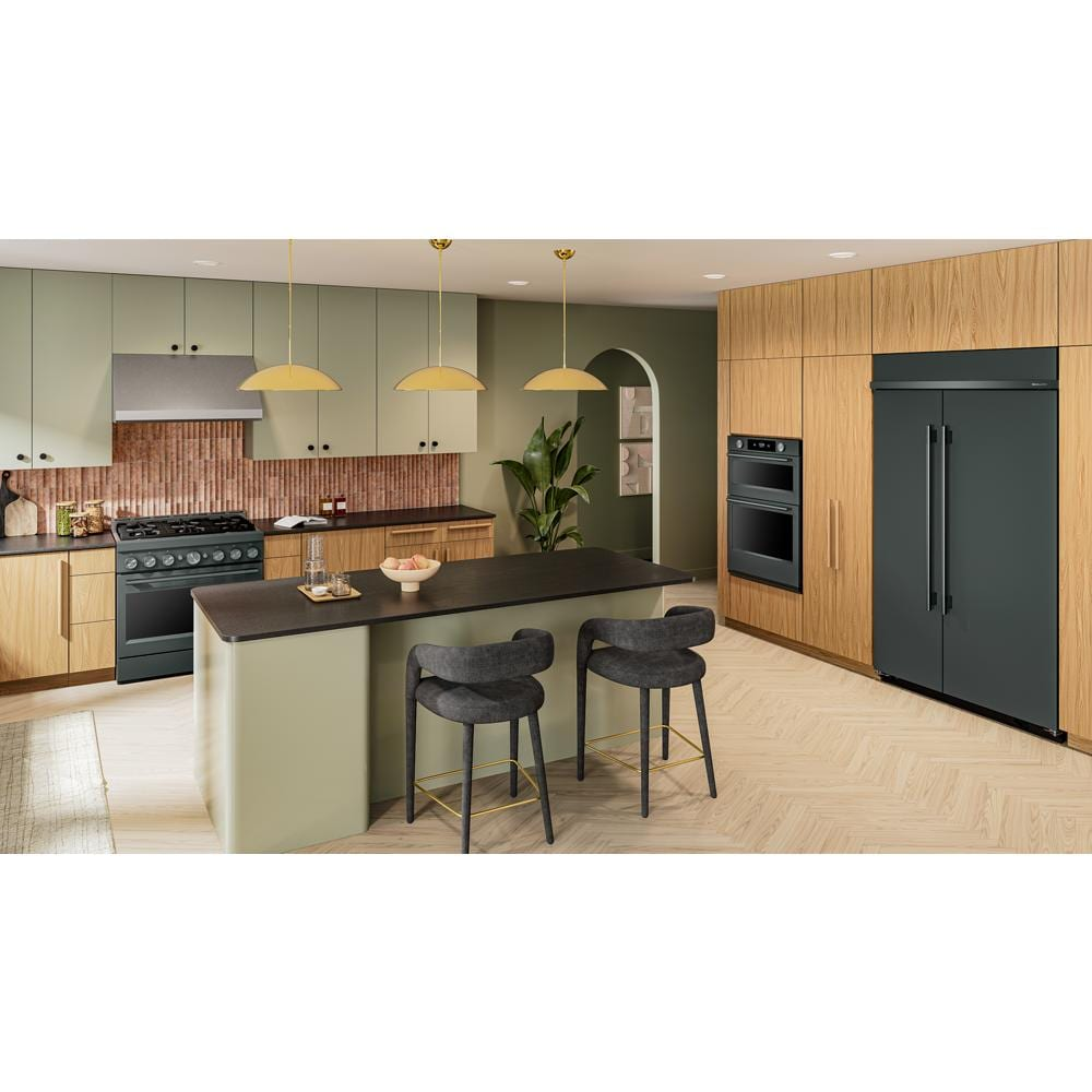 Contemporary kitchen with matte black appliances including a wall oven and large built-in refrigerator in wood and green cabinetry