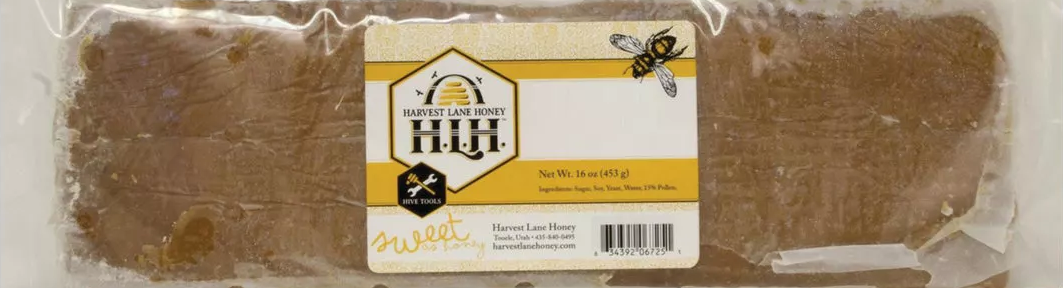 Rectangular brown bee pollen patty in clear packaging with Harvest Lane Honey label and bee illustration