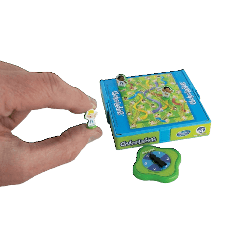 Hand holding tiny pawn figure next to compact chutes and ladders gameboard and spinner in toys under $50 collection