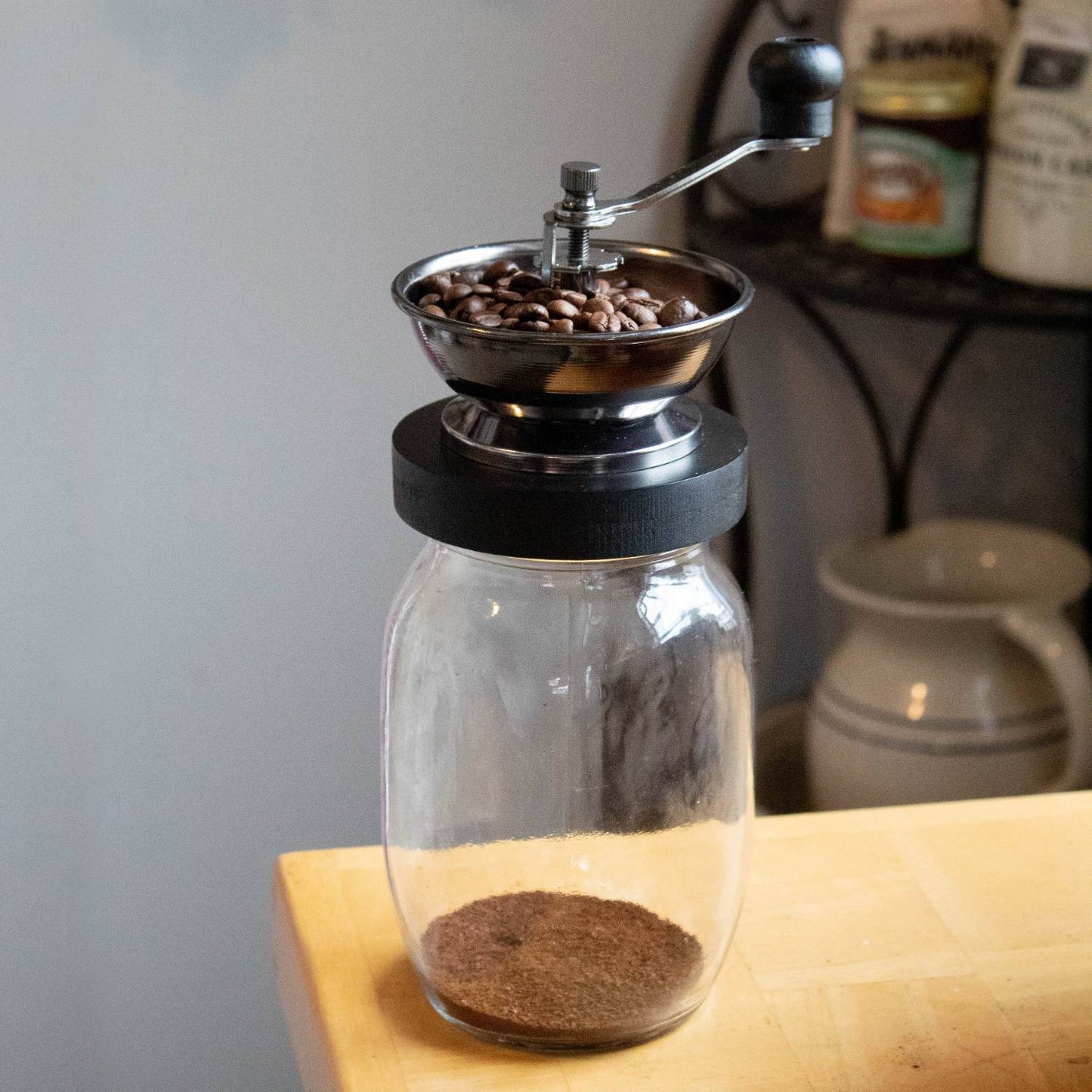 Manual coffee grinder with glass jar base and stainless steel bowl, kitchen gadget under $50 collection
