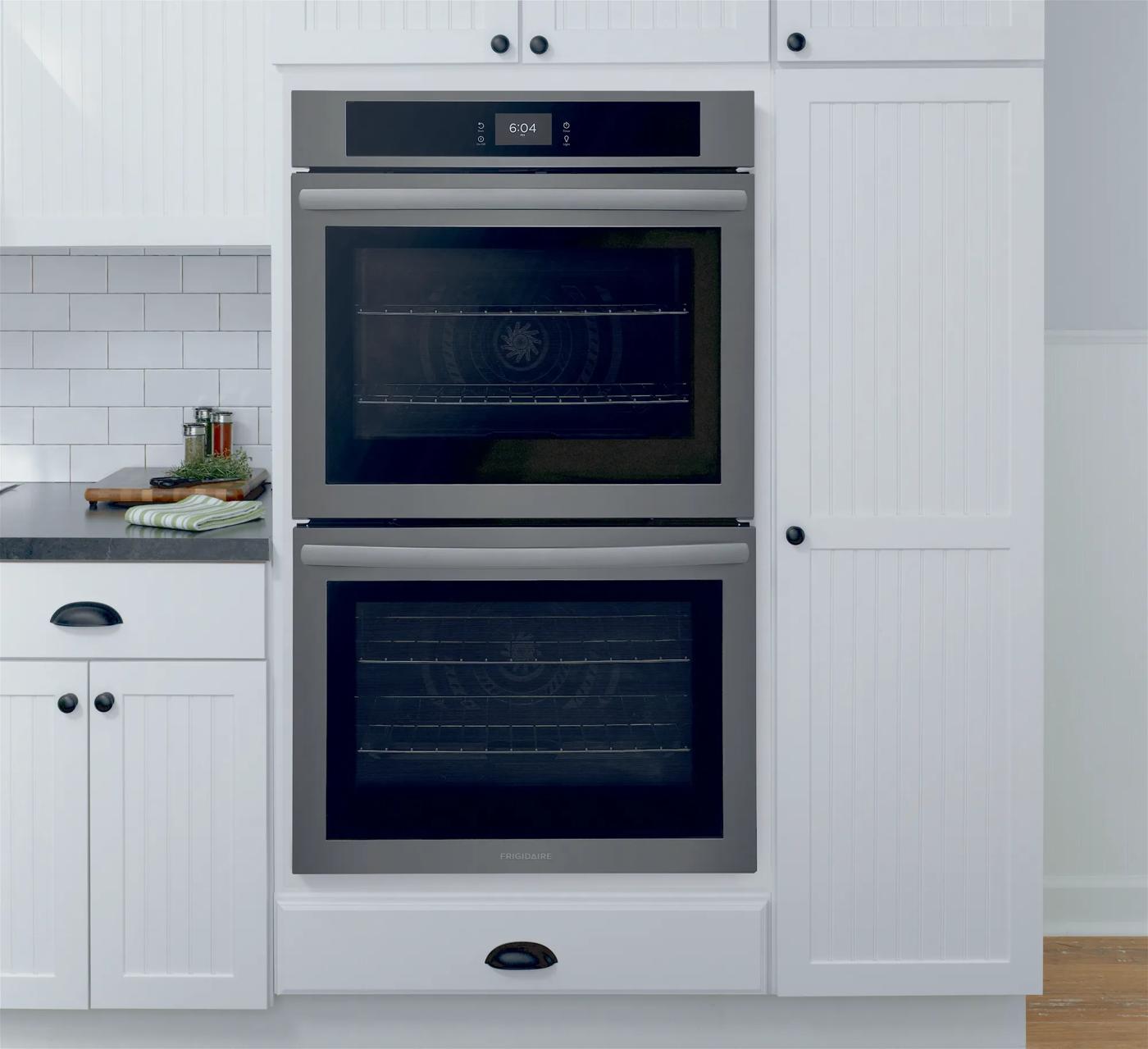 Built-in stainless steel double electric wall oven with fan convection in bright white kitchen cabinetry