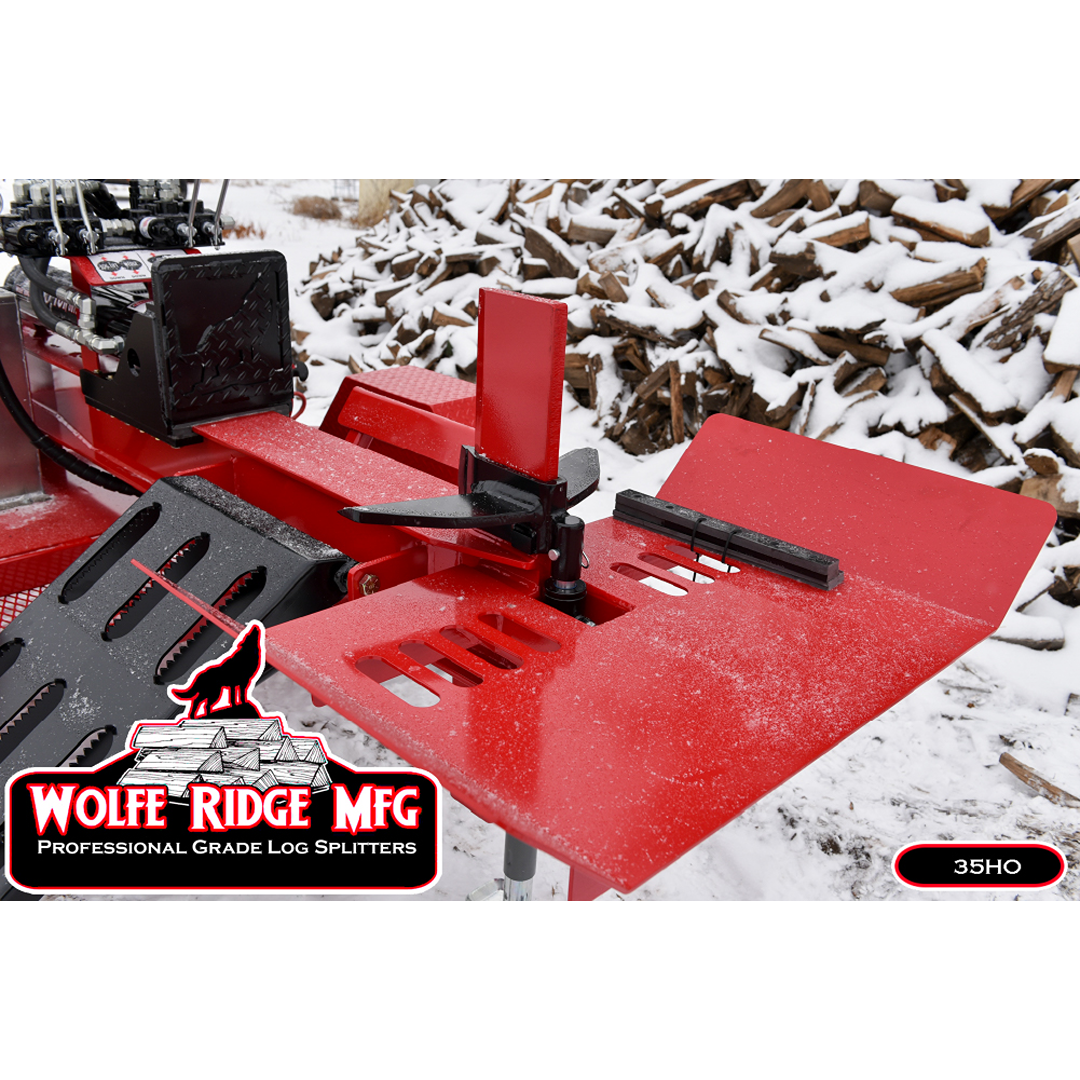 Red high-capacity log splitter push block and wedge outdoors with snow-covered stacked firewood in background