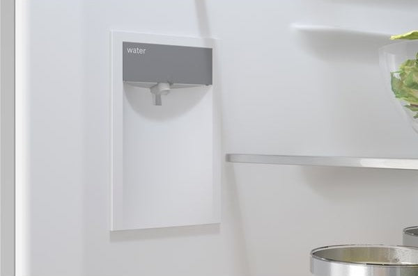 Close-up of interior water dispenser area inside a free-standing fridge-freezer in kitchen appliance collection