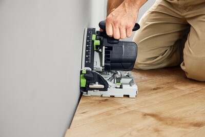 User operating Festool plunge cut track saw to make precise cuts near wall edge in home improvement power tools collection