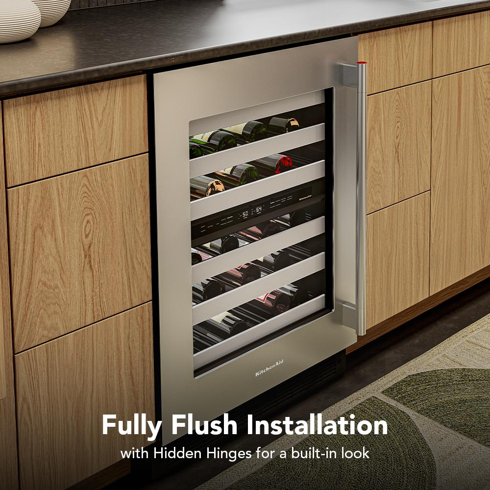 Stainless steel undercounter wine cooler with full-extension metal racks storing wine bottles in modern kitchen cabinetry