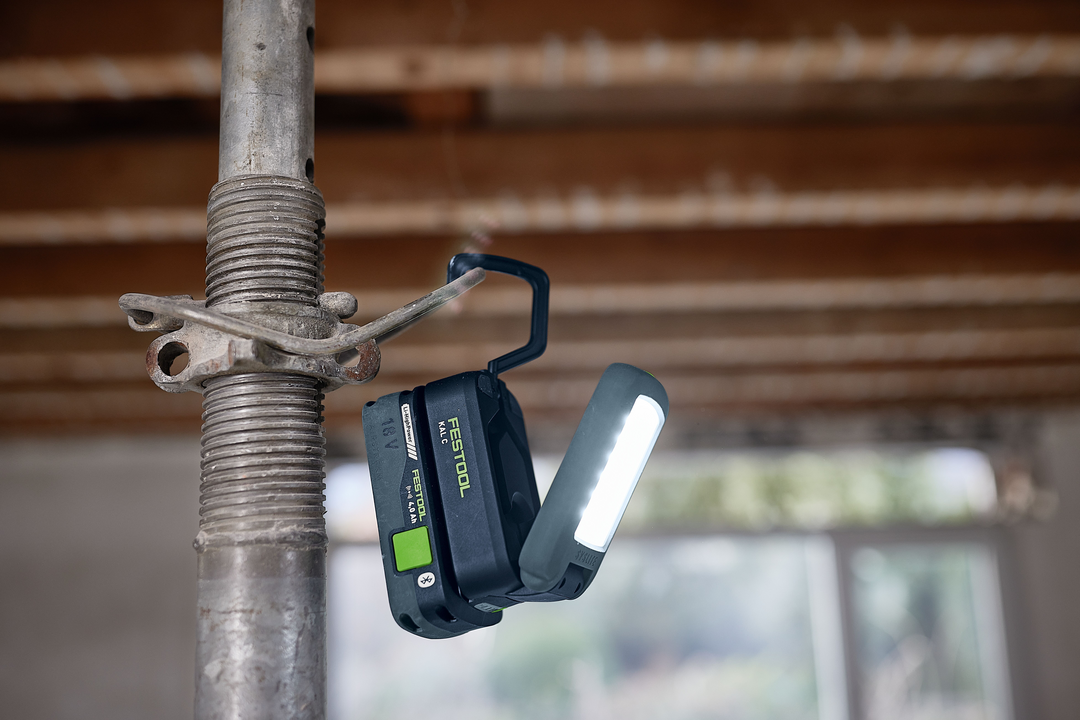 Cordless Festool Syslite task light with adjustable LED panel illuminating construction scaffolding for work lights under $100
