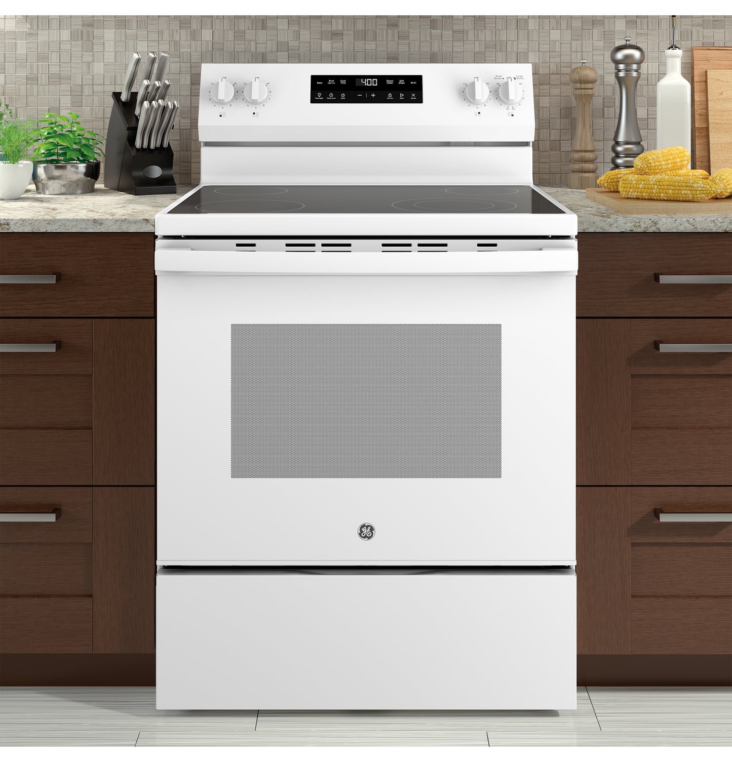 White free-standing electric range with smooth cooktop and digital display in modern kitchen setting