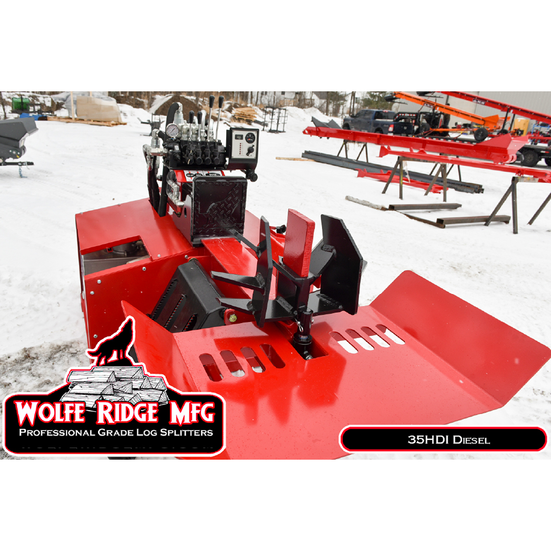 Red Wolfe Ridge industrial log splitter with box wedge and hydraulic controls set outdoors on snowy ground for firewood processing