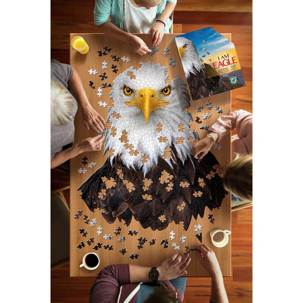 Four people assembling a shaped eagle head puzzle with missing pieces from a toys and games collection