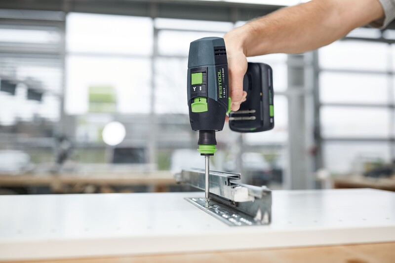 Cordless power drill driving a screw into a metal bracket for home improvement and tools projects