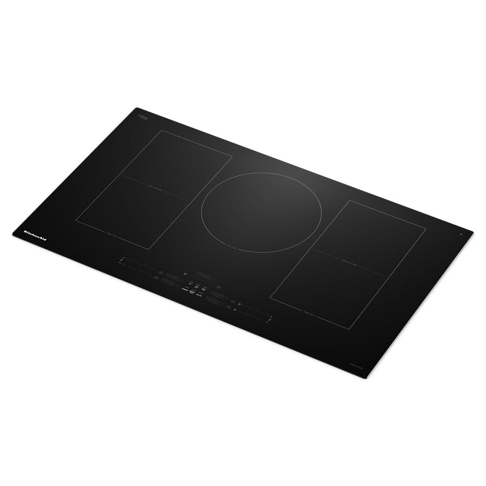 Black glass induction cooktop with five cooking zones and touch controls in KitchenAid appliances collection