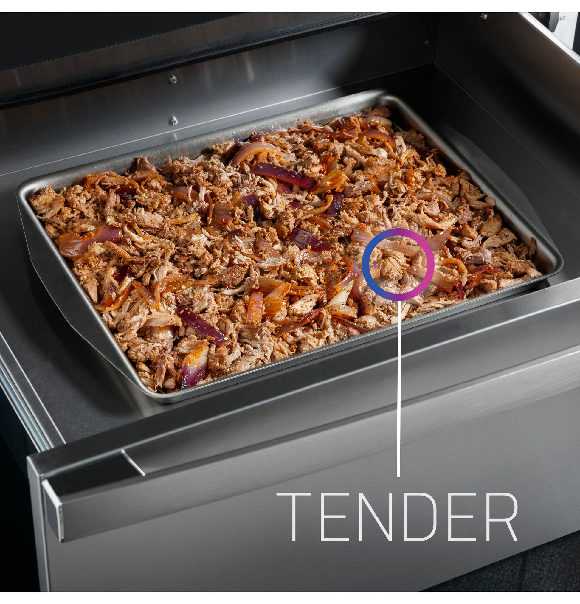 Close-up of shredded seasoned meat with onions warming inside a stainless steel warming drawer in a modern kitchen setting