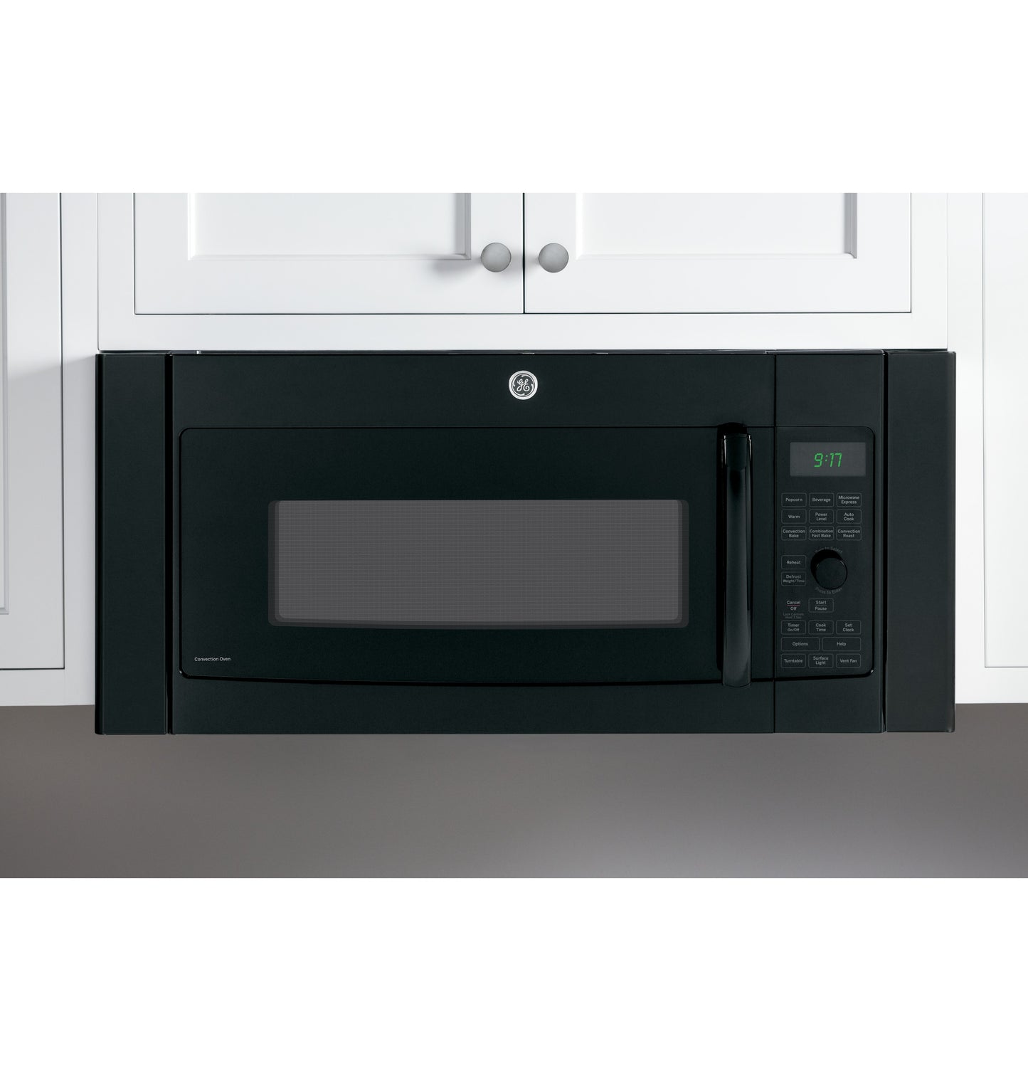Black built-in spacer kit surrounding overhead microwave between white kitchen cabinets in Appliances collection
