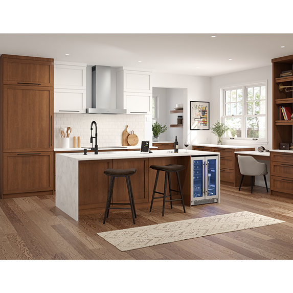 Contemporary kitchen with stainless steel wall range hood, wooden cabinets, island with stools, and built-in beverage fridge