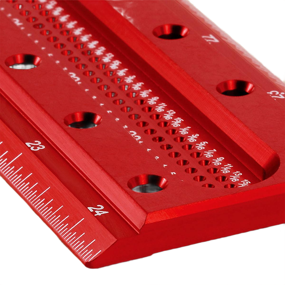 Close-up of red metal measuring tool with white engraved markings for woodworking in hand tools and measuring tools collections