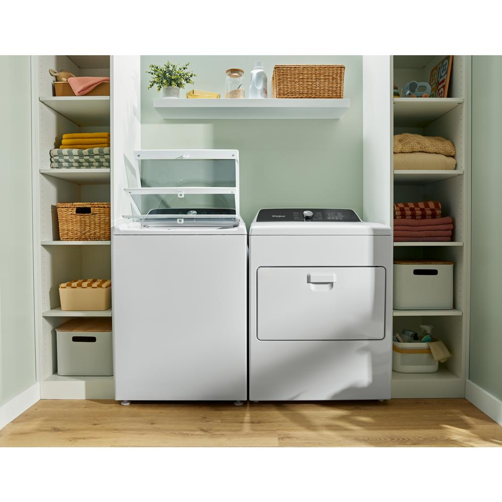 Laundry room with white top load washer and matching dryer surrounded by shelving and organized household items