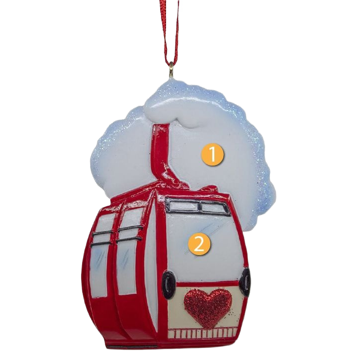 Red and white ski lift ornament with sparkling heart detail and snowy backdrop hanging from red ribbon