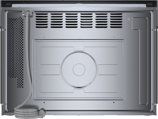 Interior view of stainless steel built-in microwave oven showing recessed glass turntable and ventilation grilles