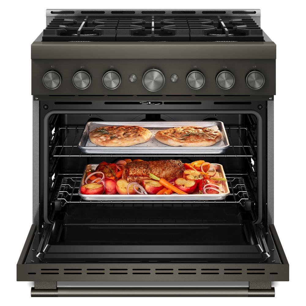 Open commercial-style gas range with two trays of cooked food and metal control knobs from kitchenware collection