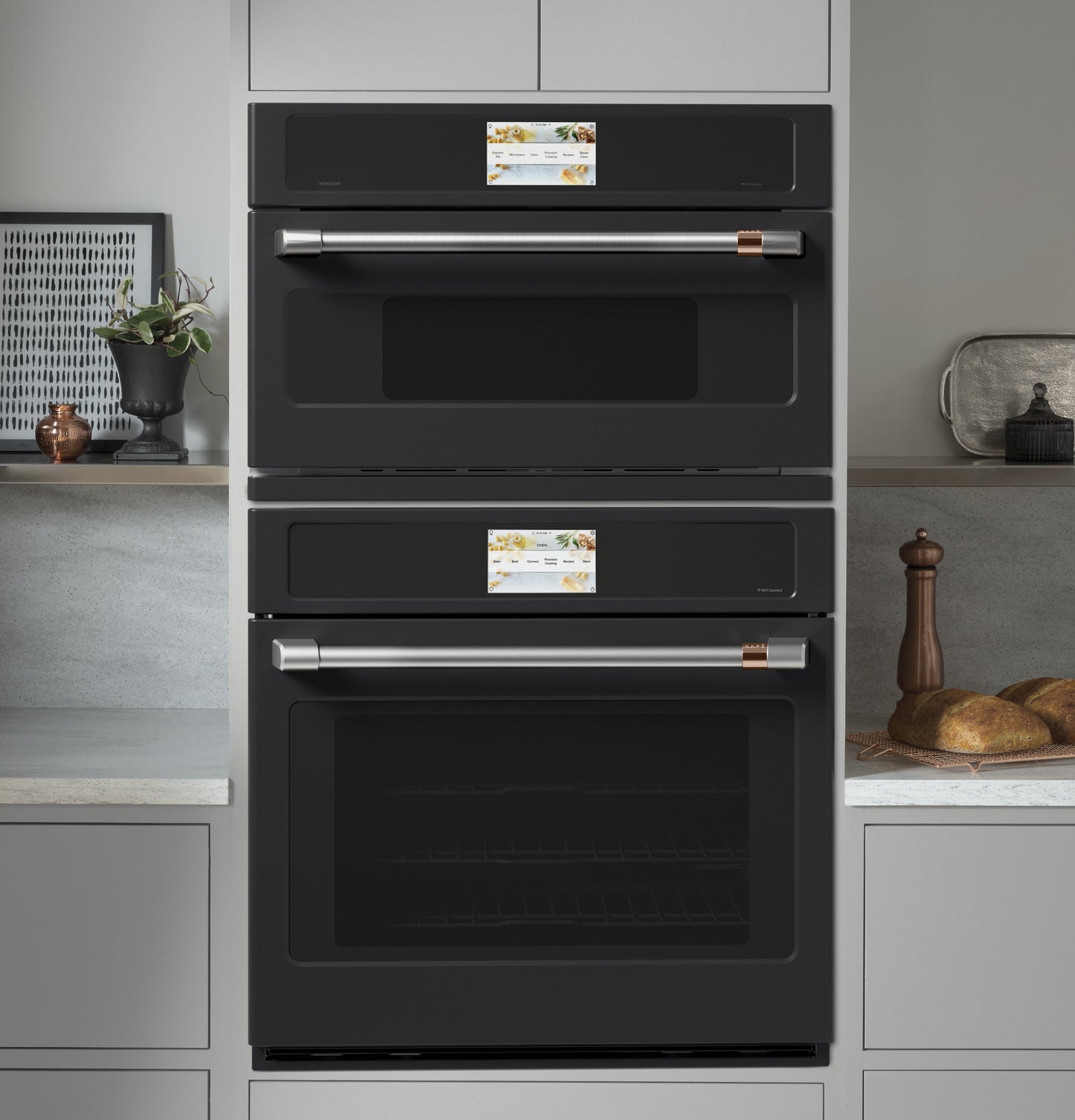 Built-in black double wall ovens with stainless steel handles and touch control panels in modern kitchen setup