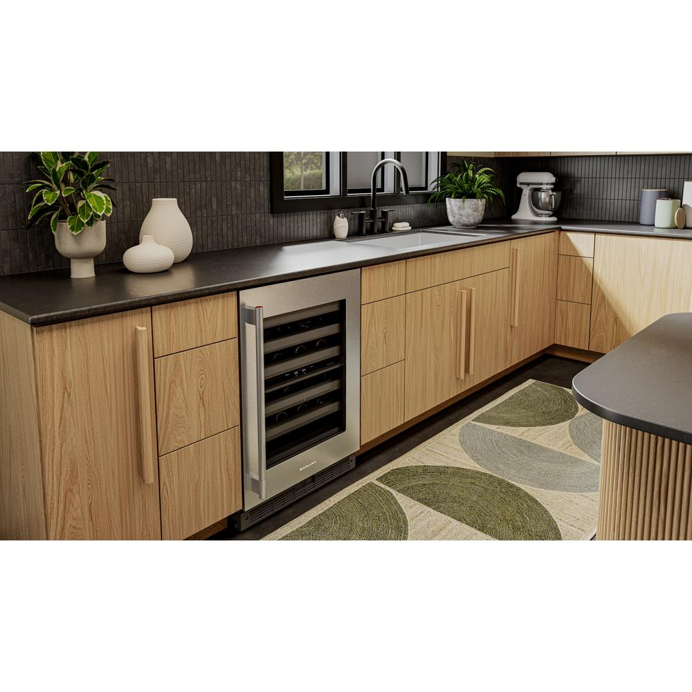Undercounter wine cooler with metal-front racks and stainless steel trim in light wood kitchen cabinetry setting