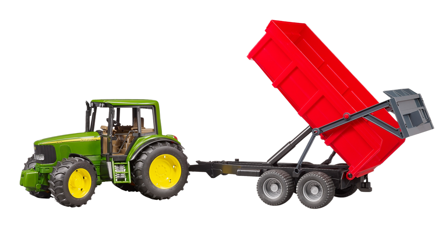 Green toy tractor with yellow wheels attached to raised red tipping trailer for realistic farm play scenarios