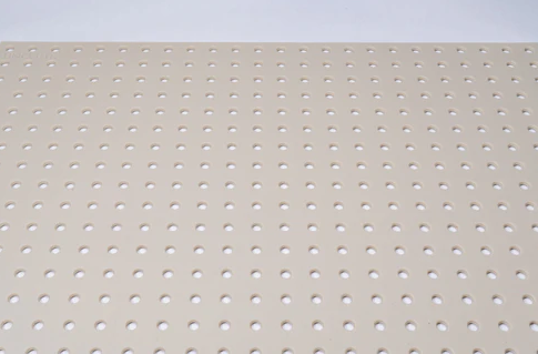Close-up of a textured silicone drawer liner with small perforations for kitchen and storage organization.