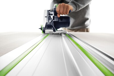 Person using a power saw on a Festool precision guide rail for clean, straight cuts in woodworking projects