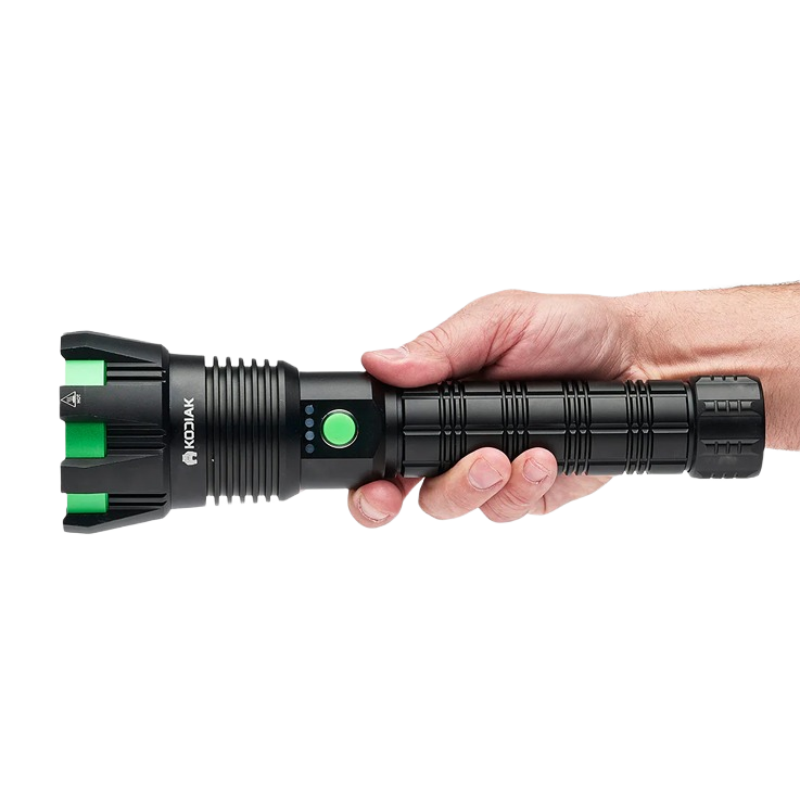 Hand holding a black Kodiak Kolossus rechargeable tactical flashlight with green accents for hand and woodworking tools collections