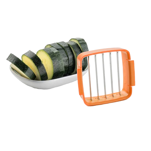 Orange handheld vegetable dicer with evenly sliced zucchini pieces on white dish for kitchenware collection under $50