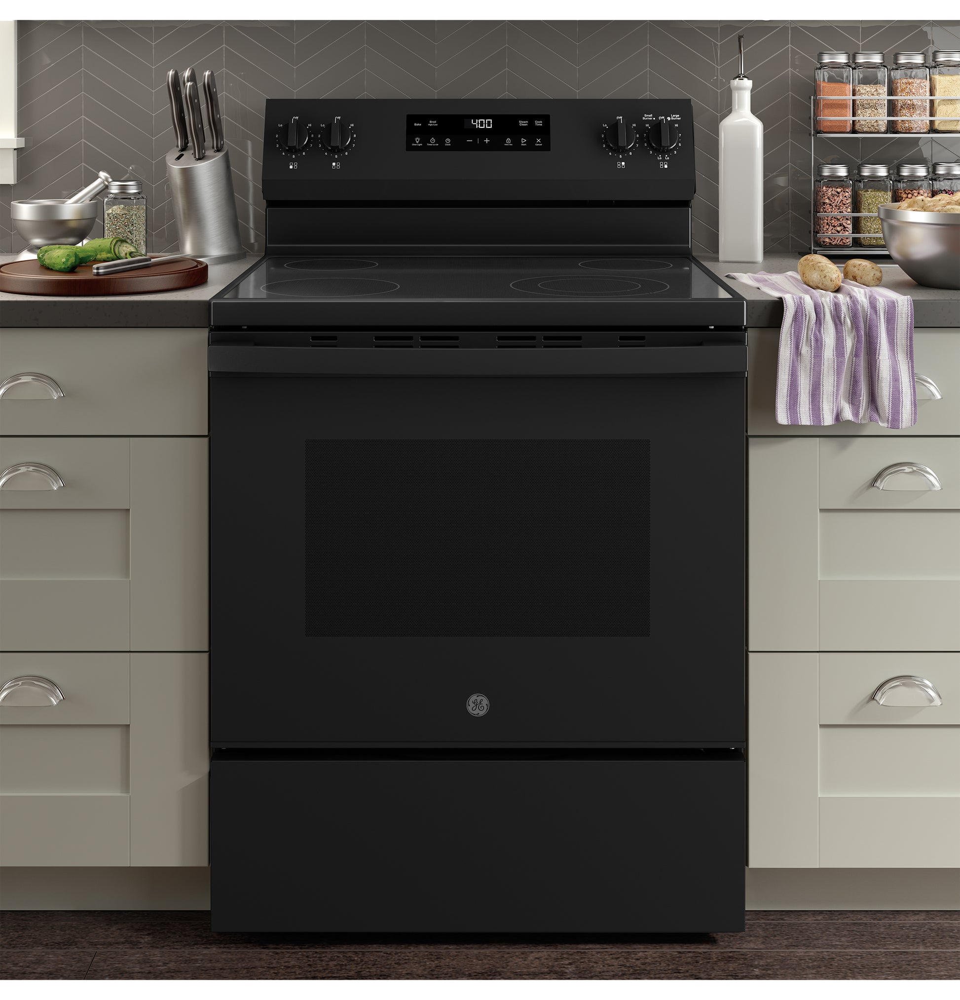 Black free-standing electric range with smooth cooktop in contemporary kitchen featuring neutral cabinetry and modern backsplash
