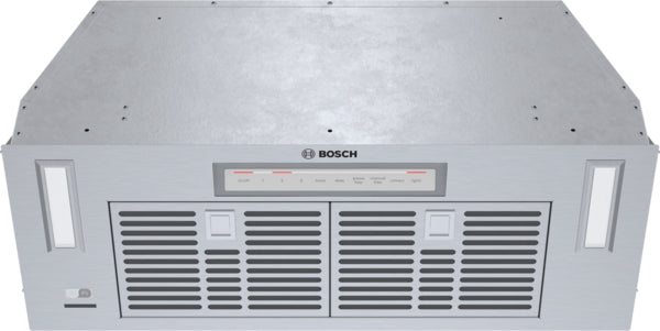 Stainless steel built-in custom insert range hood with ventilation panels and control buttons for Bosch kitchen appliances collection