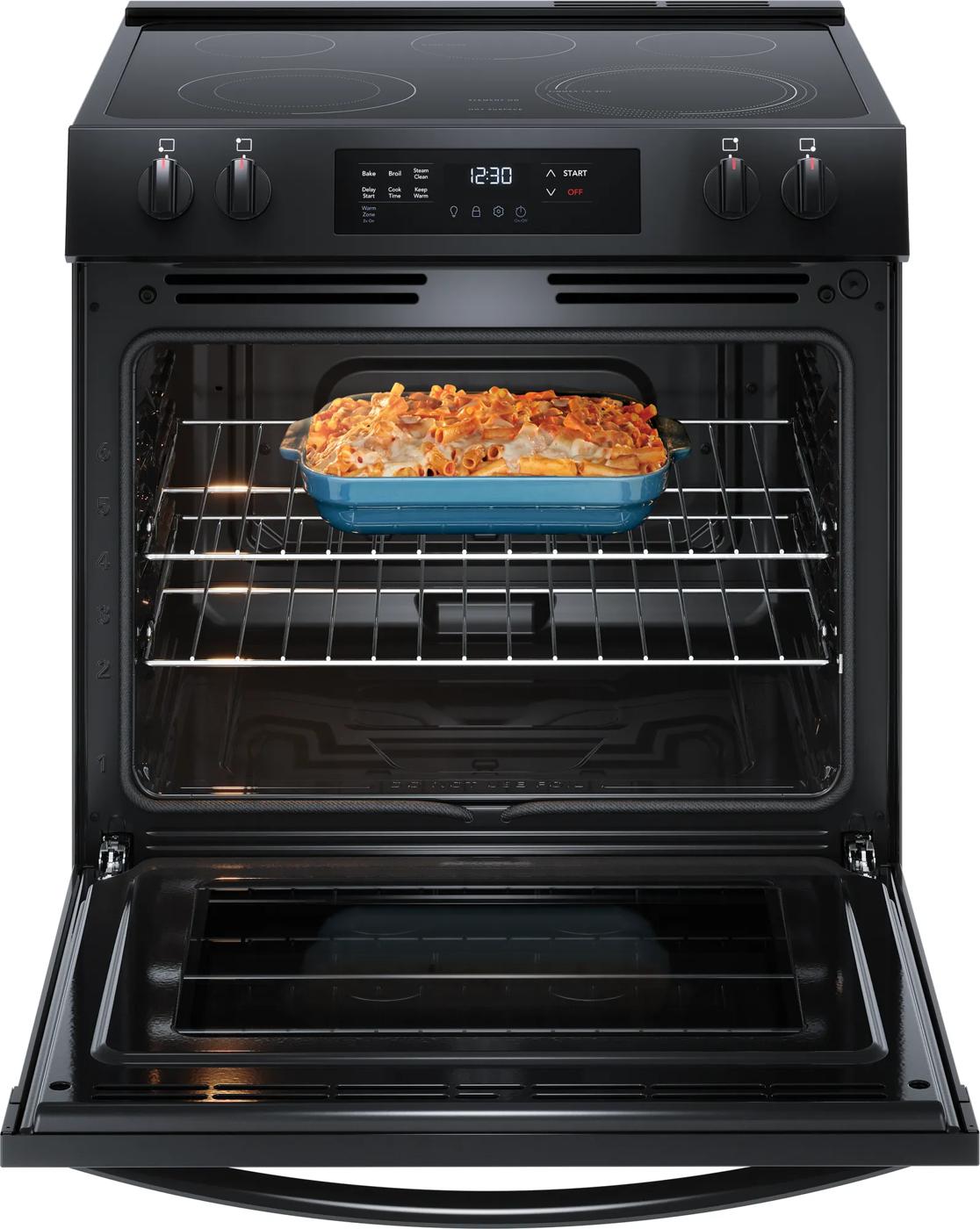 Open black electric range with baked casserole dish inside in Ranges and Kitchen & Kitchenware collections