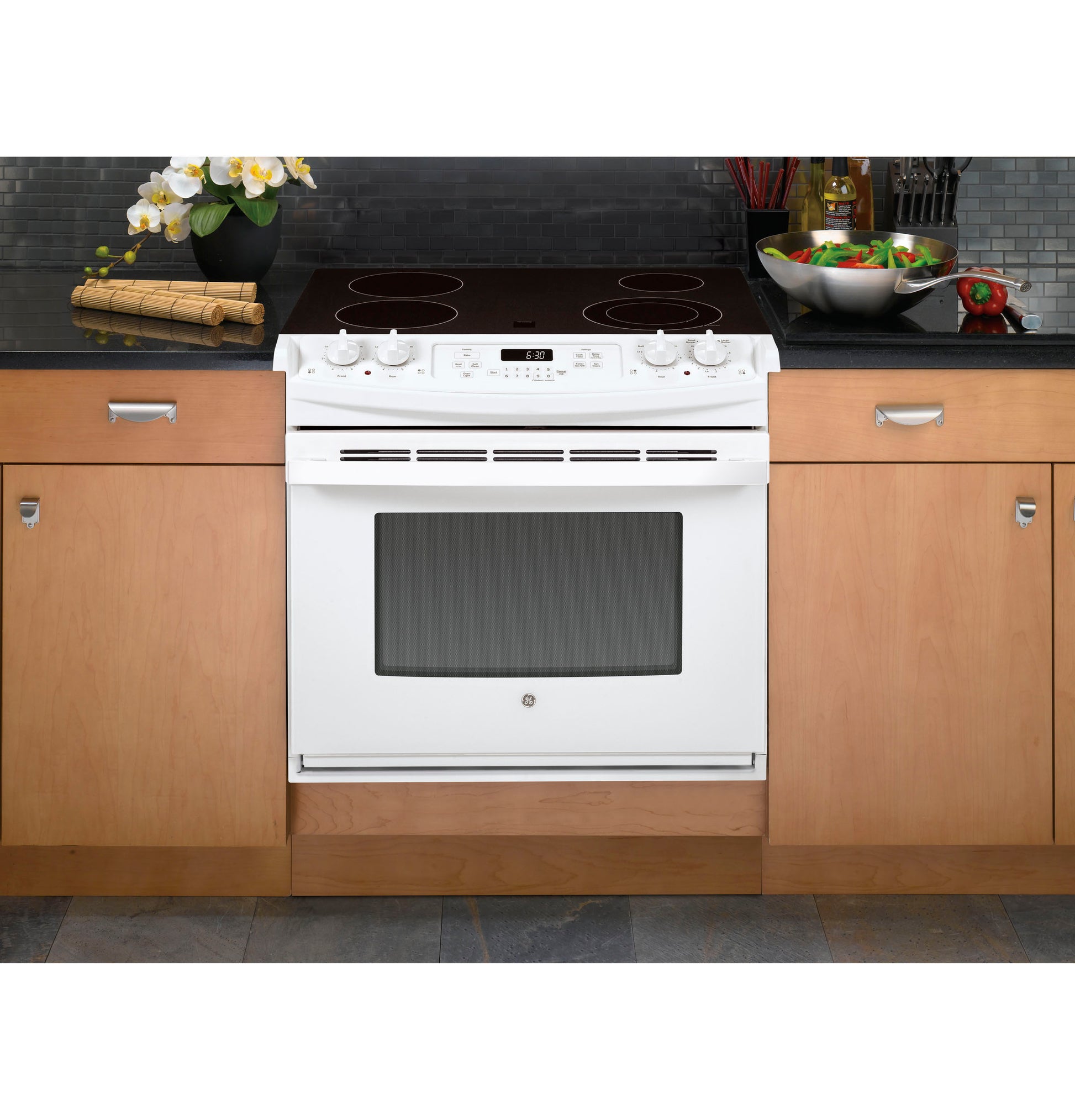 White drop-in electric range with smooth cooktop, control knobs, digital display, and oven window in kitchen appliances collection