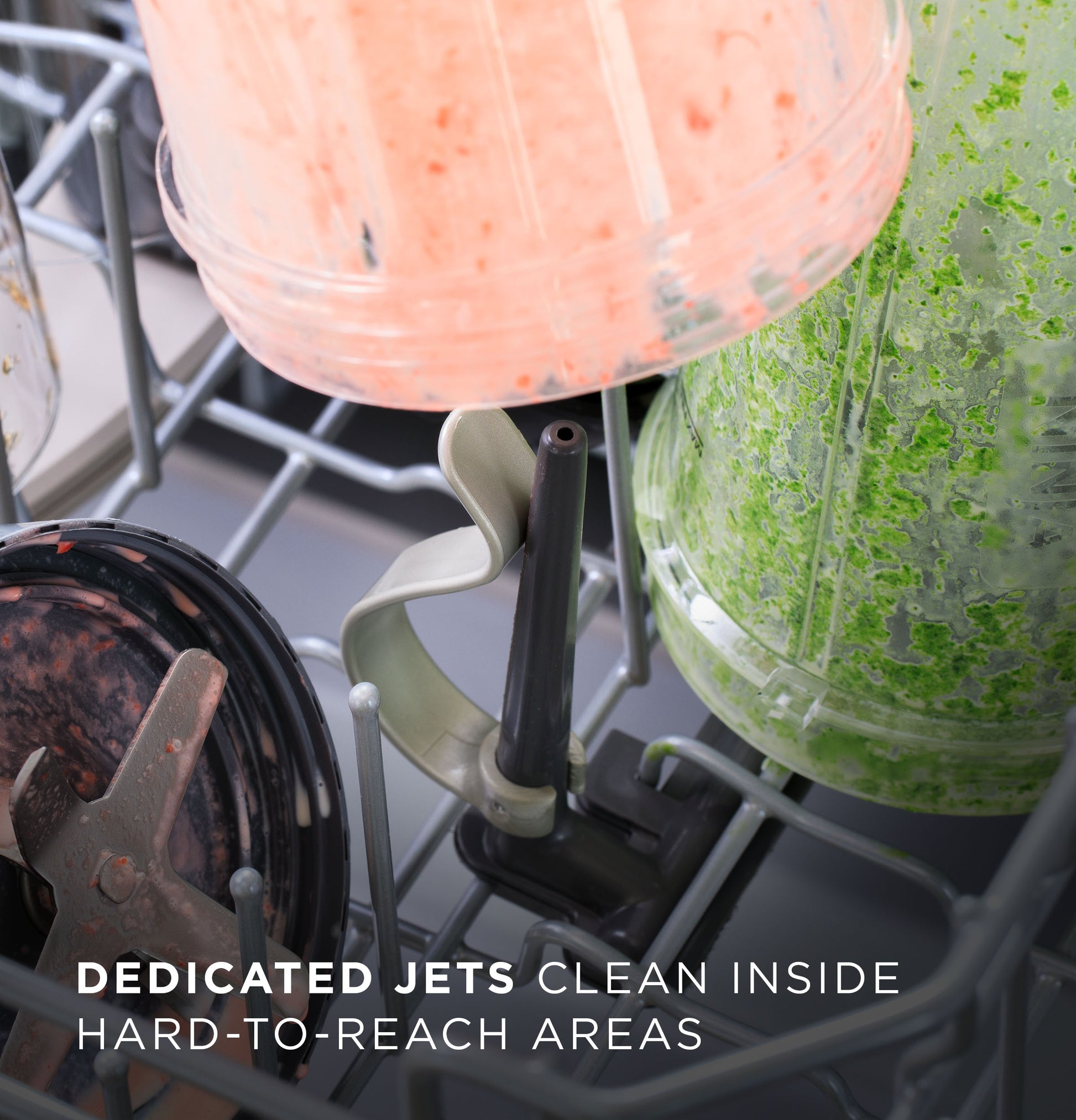 Close-up of dishwasher interior with blender parts positioned for cleaning in kitchen appliance collection.