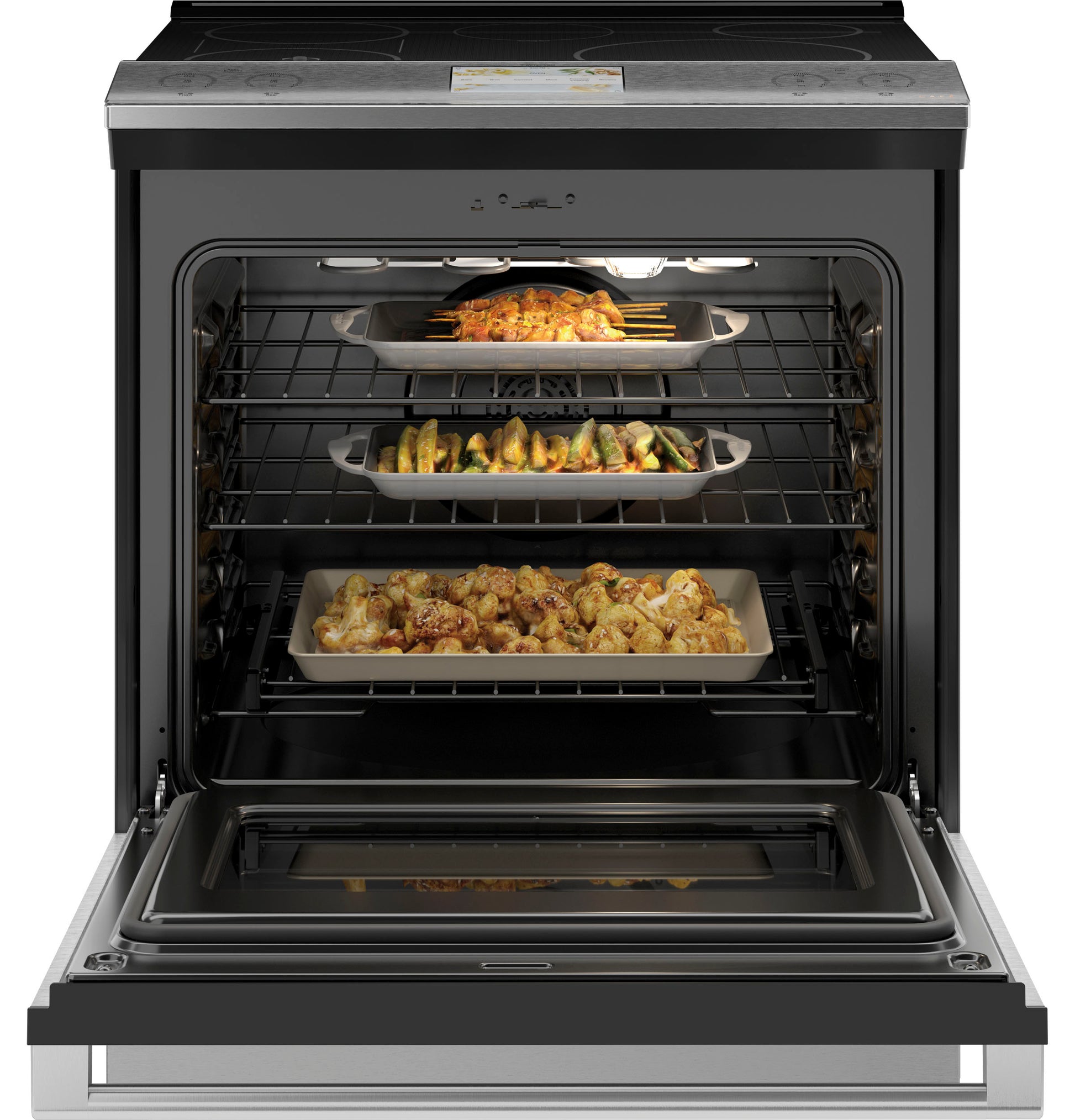 Open front-control induction and convection range oven in platinum glass with multiple trays of baked food from Ranges collection