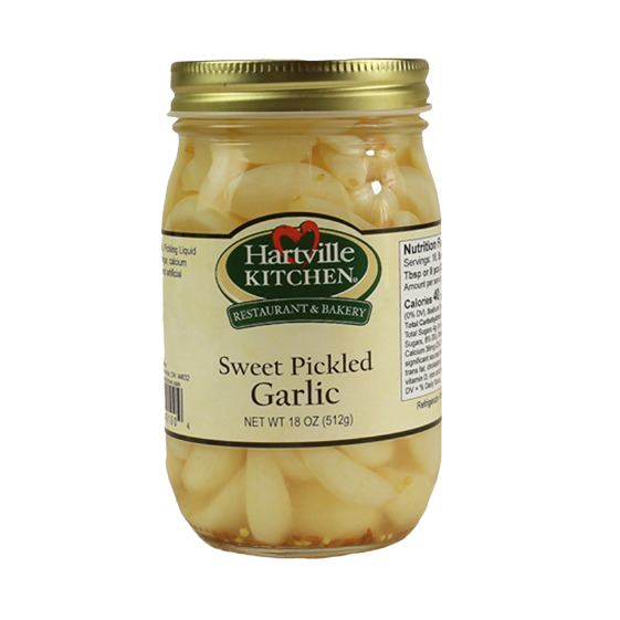 Glass jar of sweet pickled garlic cloves with gold lid from Hartville Kitchen preserved goods collection under $50