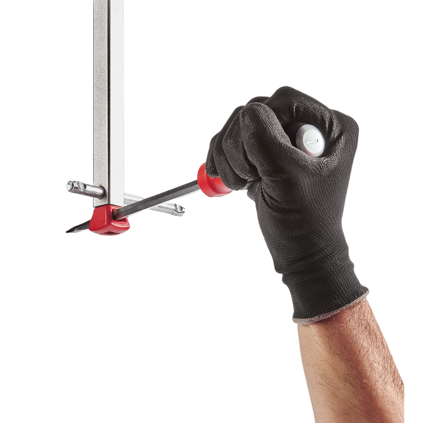 Hand wearing black glove gripping Milwaukee basin wrench with ergonomic handle for plumbing and home improvement tasks
