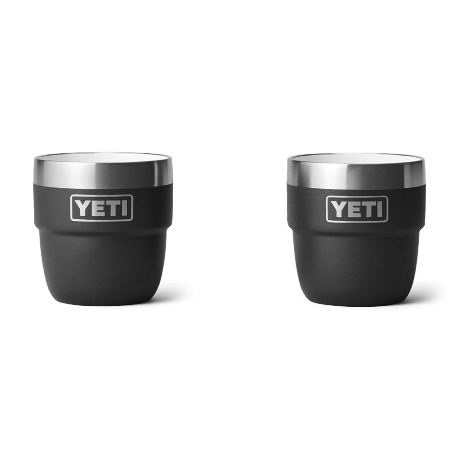 Two black stackable 4 oz. cups with stainless steel rims featuring a durable insulated design for drinkware use