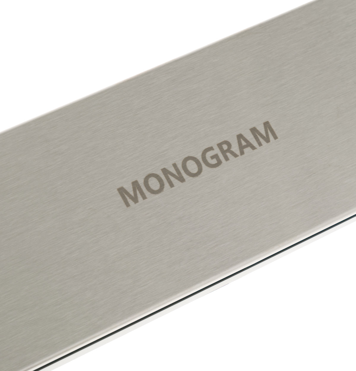 Brushed stainless steel panel with Monogram logo detail for built-in microwave in kitchenware and appliances collections