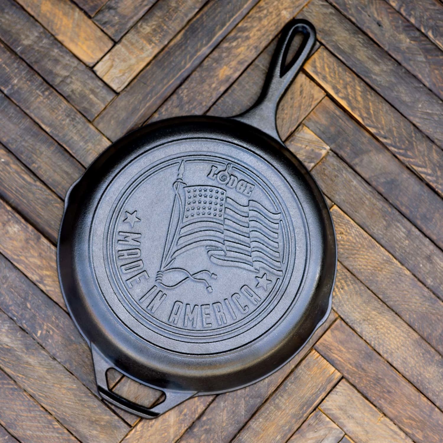 Overhead view of black cast iron skillet with embossed American flag and Made in America text on wooden surface