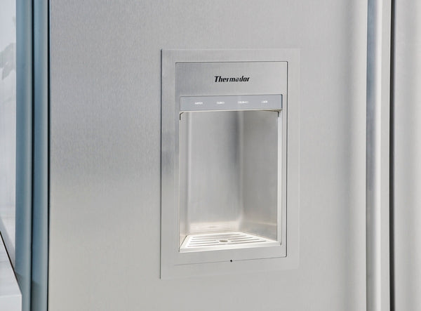 Stainless steel external ice and water dispenser integrated into a built-in freezer column for kitchen appliances